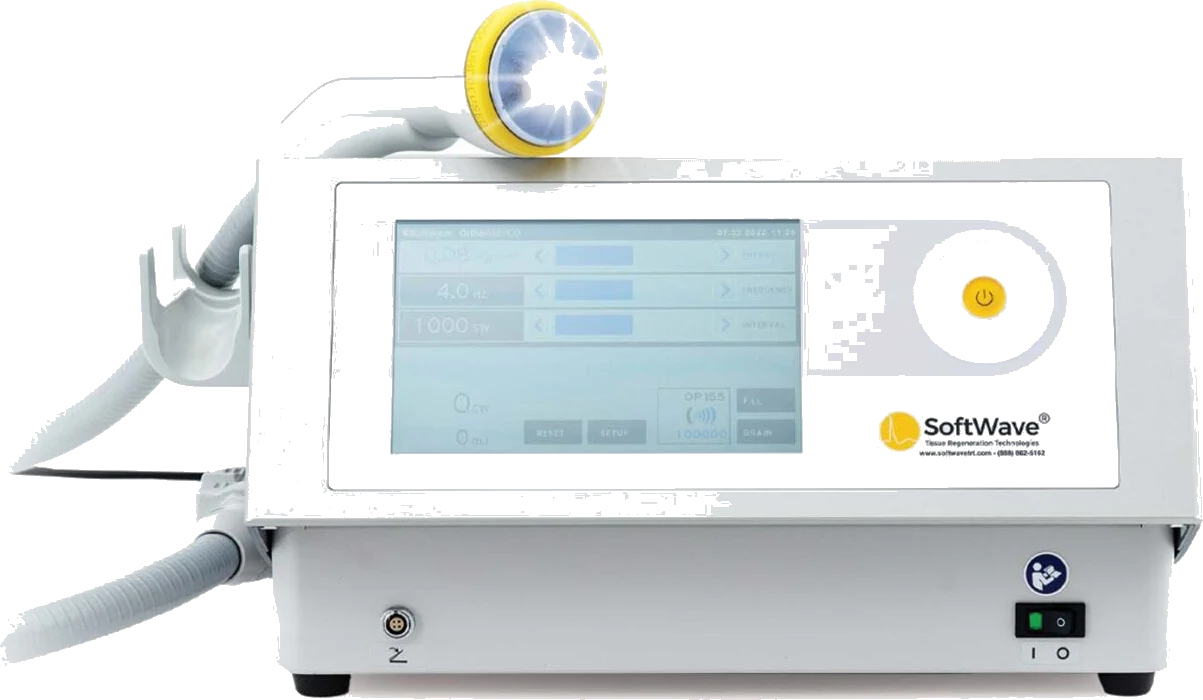 A shockwave therapy console with its handpiece resting on top.